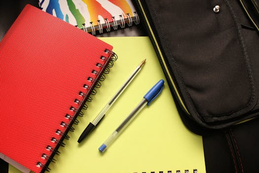 school-notebook-binders-notepad-159497-159497 A close-up view of colorful notebooks and pens, perfect for educational themes.